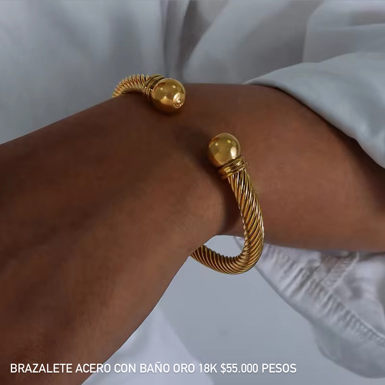 Brazalete acero con baño oro 18k